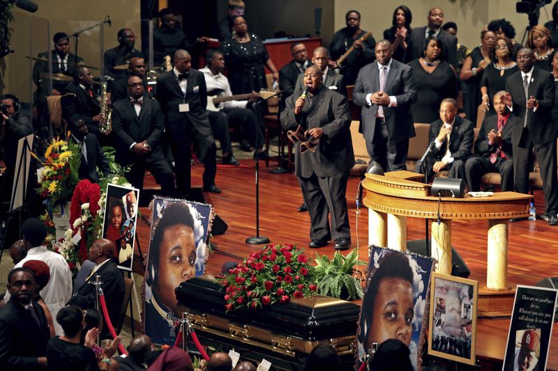 FILE - Pictures of Michael Brown flank his casket during his funeral, Aug. 25, 2014, at Friendly Temple Missionary Baptist Church in St. Louis. Hundreds of people gathered to say goodbye to Brown, who was shot and killed by a Ferguson, Mo., police officer on Aug. 9. (Robert Cohen/St. Louis Post-Dispatch via AP, Pool, File)