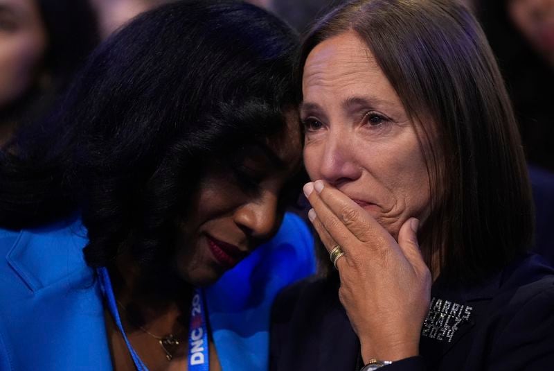 Delegates react as Jon Polin and Rachel Goldberg, parents of hostage Hersh Goldberg-Polin speak during the Democratic National Convention Wednesday, Aug. 21, 2024, in Chicago. (AP Photo/Erin Hooley)