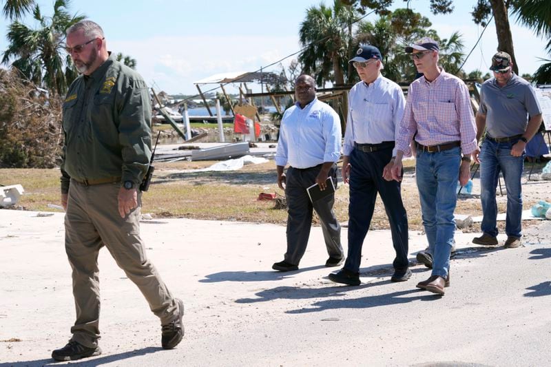 Sen. Rick Scott, R-Fla., from second right, President Joe Biden and Deputy Administrator Erik Hooks, Federal Emergency and Management Agency, walk and view damage from Hurricane Helene in Keaton Beach, Fla., Thursday, Oct. 3, 2024. (AP Photo/Susan Walsh)