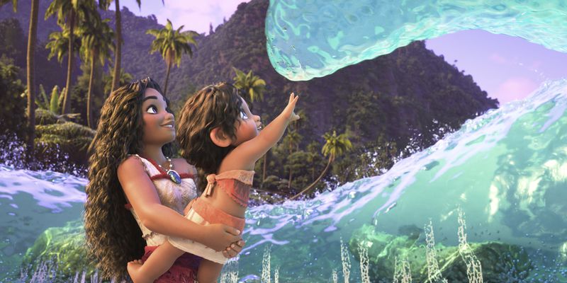 This image released by Disney shows Moana, voiced by Auli'i Cravalho holding Simea, voiced by Khaleesi Lambert-Tsuda, in a scene from "Moana 2." (Disney via AP)