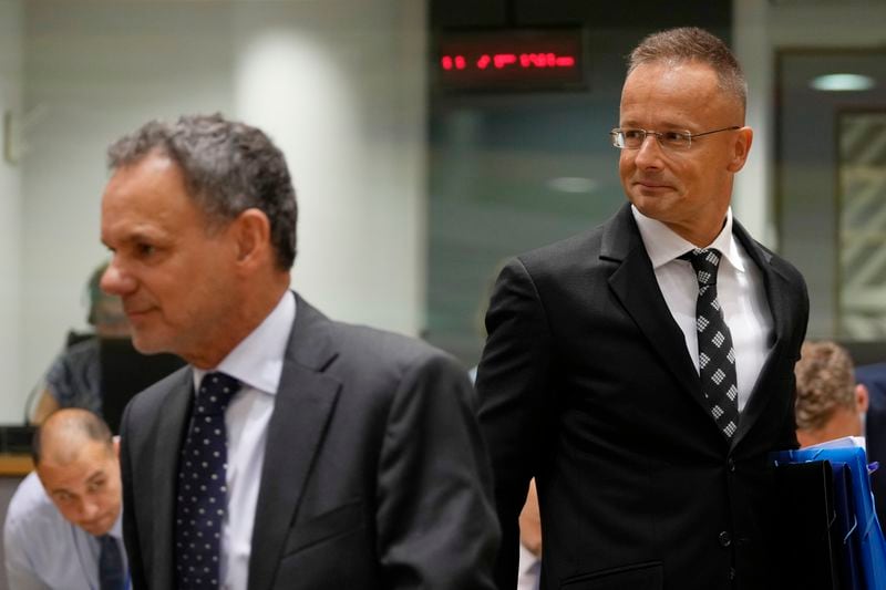 Hungary's Foreign Minister Peter Szijjarto, right, arrives for a meeting of EU foreign ministers at the European Council building in Brussels, Thursday, Aug. 29, 2024. (AP Photo/Virginia Mayo)