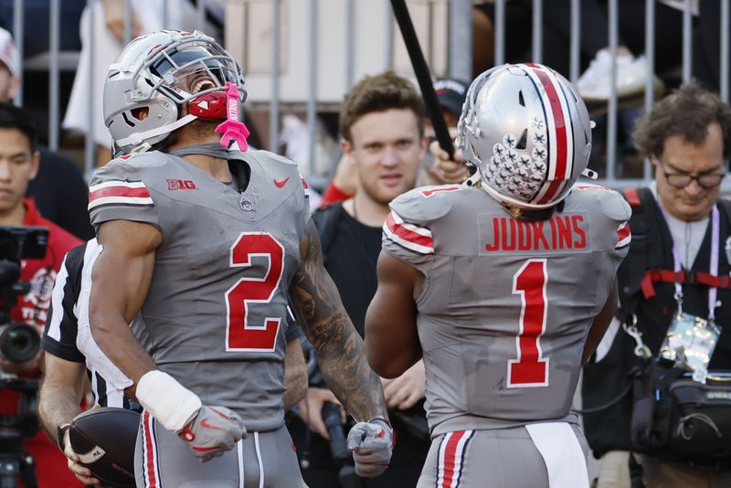 Ohio State receiver Emeka Egbuka, left, and running back Quinshon Judkins celebrate their touchdown against Iowa during the second half of an NCAA college football game, Saturday, Oct. 5, 2024, in Columbus, Ohio. (AP Photo/Jay LaPrete)