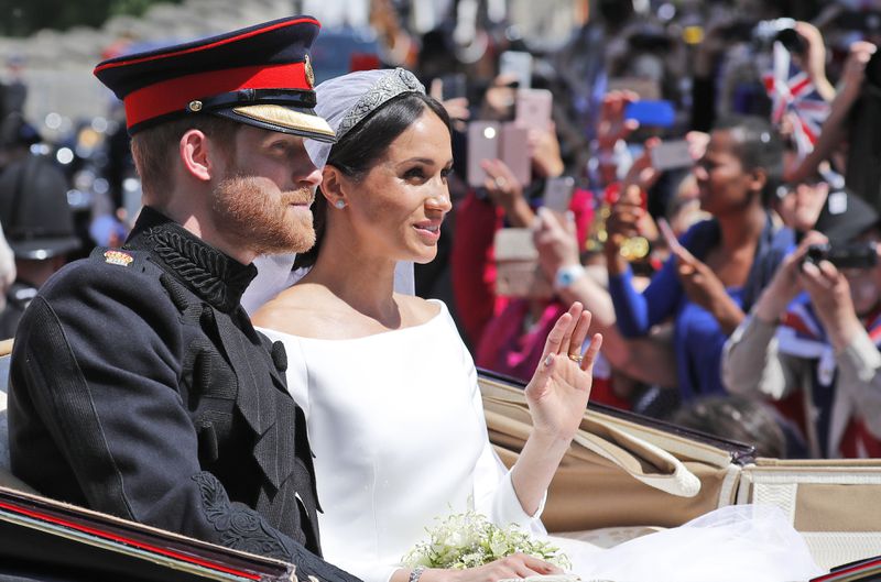 FILE - Britain's Prince Harry and his bride Meghan Markle, ride in a carriage after their wedding ceremony at St. George's Chapel in Windsor Castle in Windsor, near London, England, Saturday, May 19, 2018. (AP Photo/Frank Augstein, File)