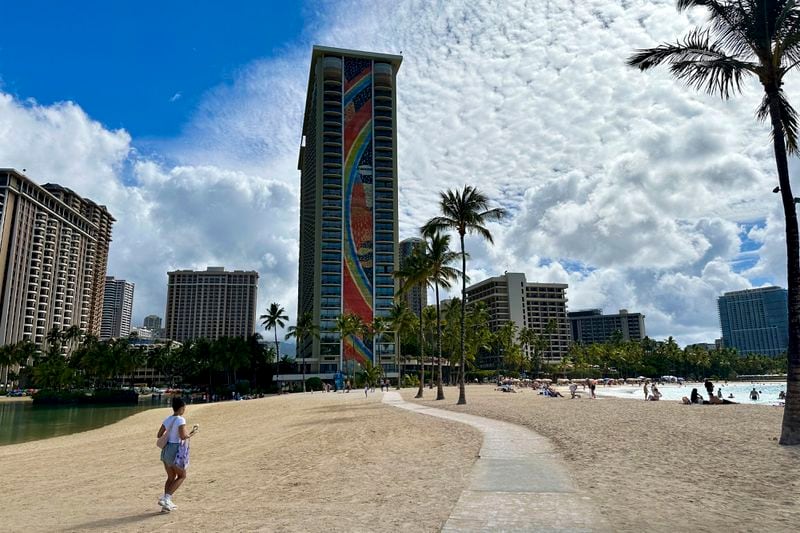 The Hilton Hawaiian Village's rainbow-covered building is seen from the beach on Tuesday, Sept. 24, 2024, in Honolulu. (AP Photo/Jennifer Sinco Kelleher)