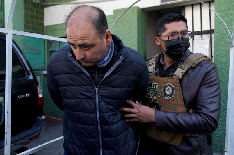 Colonel Edison Alejandro Caero, detained for his involvement in what President Luis Arce called a coup attempt, is escorted from a jail to be taken to Chonchocoro maximum security prison, in La Paz, Bolivia, Saturday, June 29, 2024. (AP Photo/Juan Karita)
