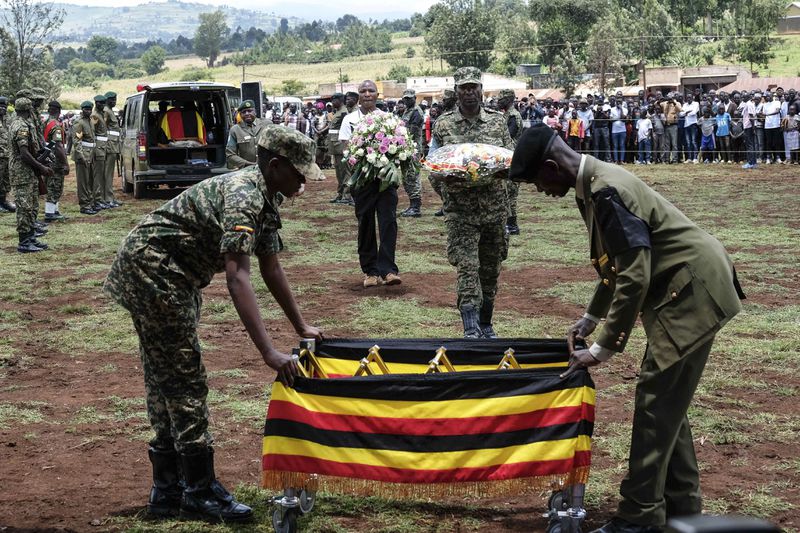 Members of the Uganda People's Defense Force carry the casket of Ugandan Olympic athlete Rebecca Cheptegei ahead of her burial in Kapkoros, Bukwo District, Uganda, on Saturday, Sept. 14. 2024. (AP Photo/Hajarah Nalwadda)