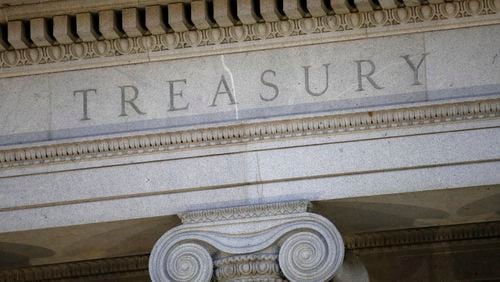 FILE- This June 6, 2019, file photo shows the U.S. Treasury Department building at dusk in Washington. (AP Photo/Patrick Semansky, File)