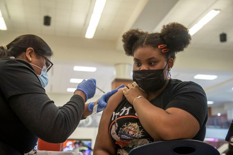 Discovery High School junior Morgan Scott receives a vaccine in August during an event in Lawrenceville. Georgia’s vaccination efforts against COVID-19 lagged most other U.S. states during 2021. (Alyssa Pointer/AJC file photo)
