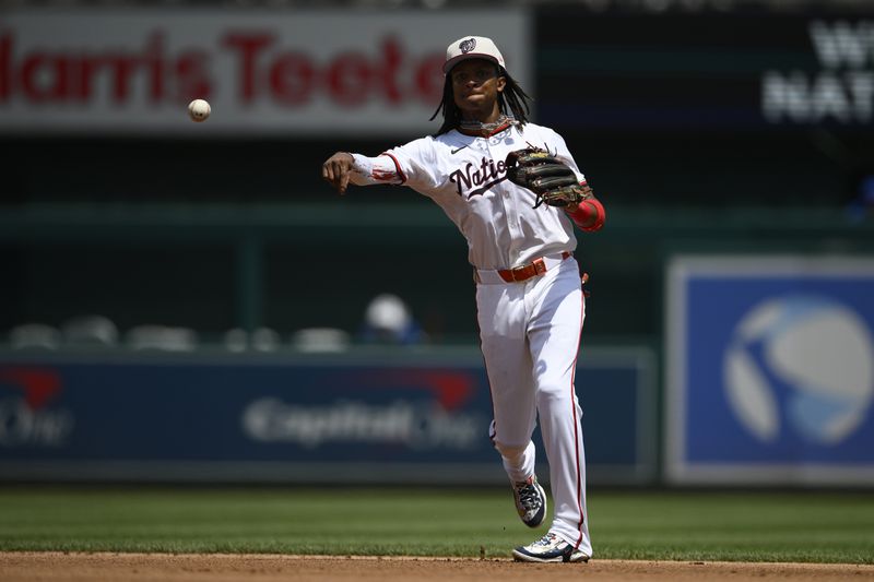 Washington Nationals shortstop CJ Abrams (5) throws to first base to put out New York Mets' Ben Gamel during the fifth inning of a baseball game, Thursday, July 4, 2024, in Washington. (AP Photo/Nick Wass)