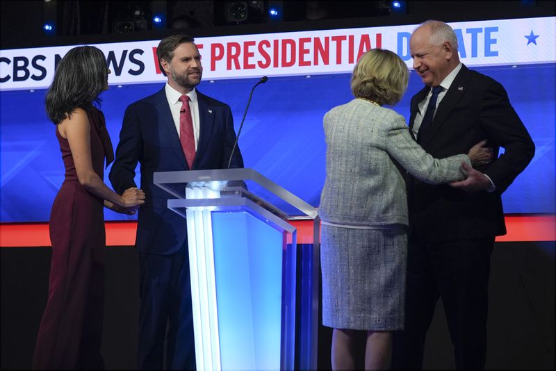 Republican vice presidential nominee Sen. JD Vance, R-Ohio, and his wife Usha Vance and and Democratic vice presidential candidate Minnesota Gov. Tim Walz and his wife Gwen Walz stand on stage after the vice presidential debate hosted by CBS News, Tuesday, Oct. 1, 2024, in New York. (AP Photo/Matt Rourke)