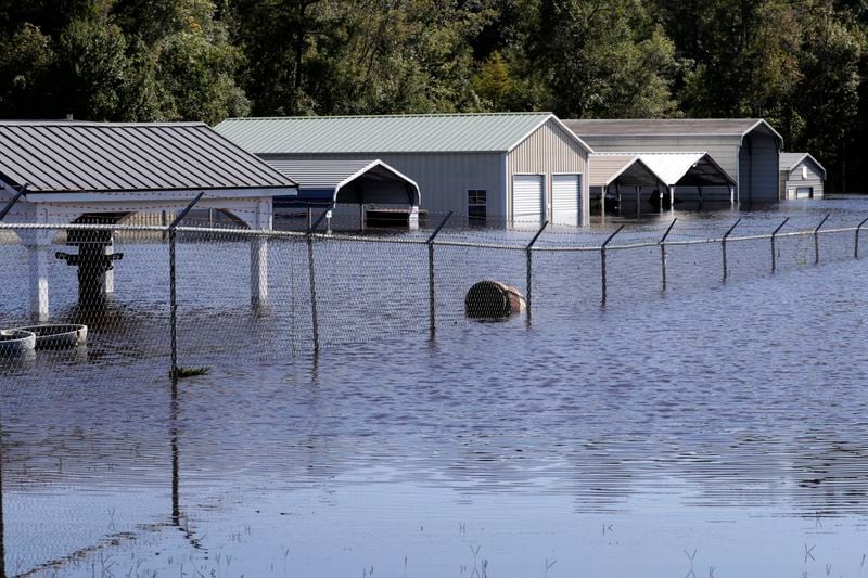 Floodwaters inundated the Trademark Outdoors business on U.S. Highway 17 in Supply, N.C., Tuesday, Sept. 17, 2024. (AP Photo/Chris Seward)