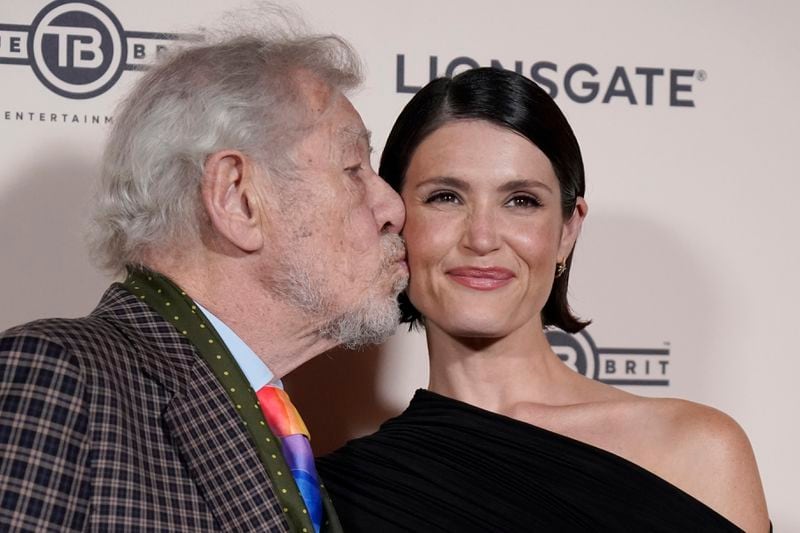 Ian McKellen, kisses co-star Gemma Arterton, as they pose for photographers upon arrival at the European Premiere of the The Critic, In London, Monday, Sept. 2, 2024. (AP Photo/Alberto Pezzali)