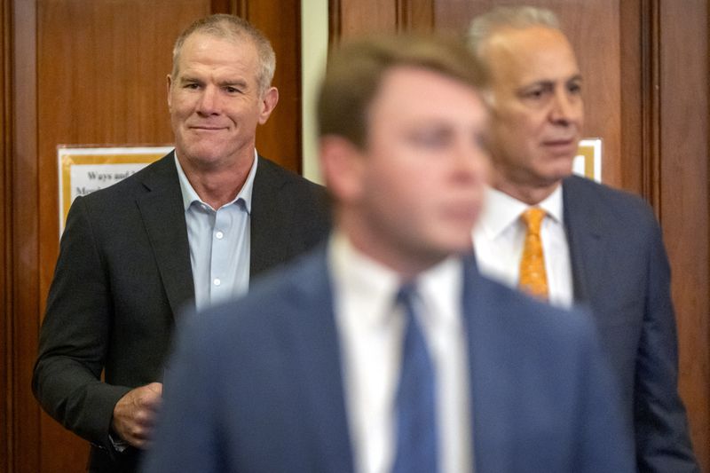 Former NFL quarterback Brett Favre, left, arrives to appear before the House Committee on Ways and Means on Capitol Hill, Tuesday, Sept. 24, 2024, in Washington. (AP Photo/Mark Schiefelbein)