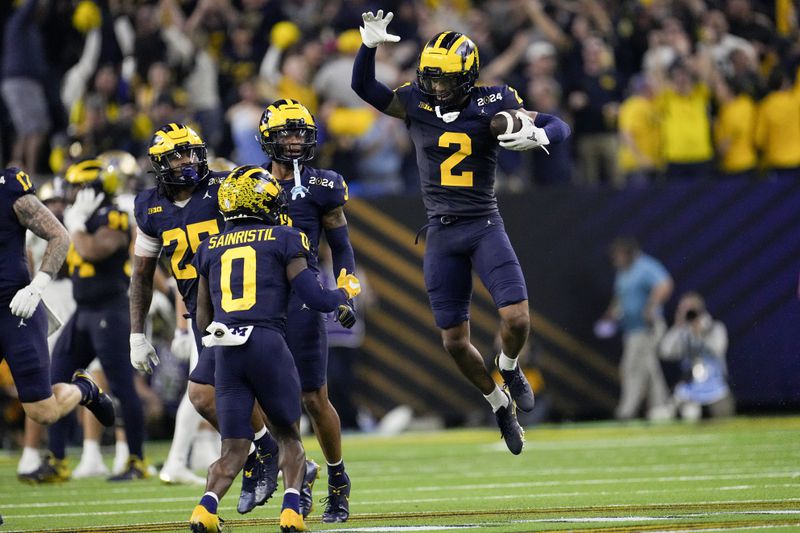 FILE - Michigan defensive back Will Johnson celebrates after an interception against Washington during the second half of the national championship NCAA College Football Playoff game, Monday, Jan. 8, 2024, in Houston. (AP Photo/David J. Phillip, File)