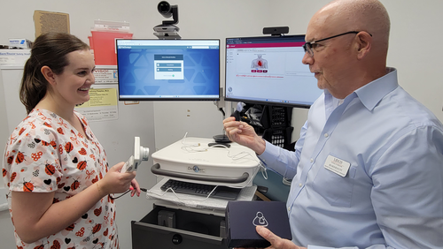 Ed Honeycutt trains Brittany Lord in telehealth services.