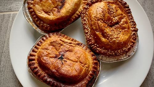 Here are three double-crust pies from Panbury's (clockwise from top): chicken and bacon, spinach and feta, and steak and stout. Henri Hollis/henri.hollis@ajc.com