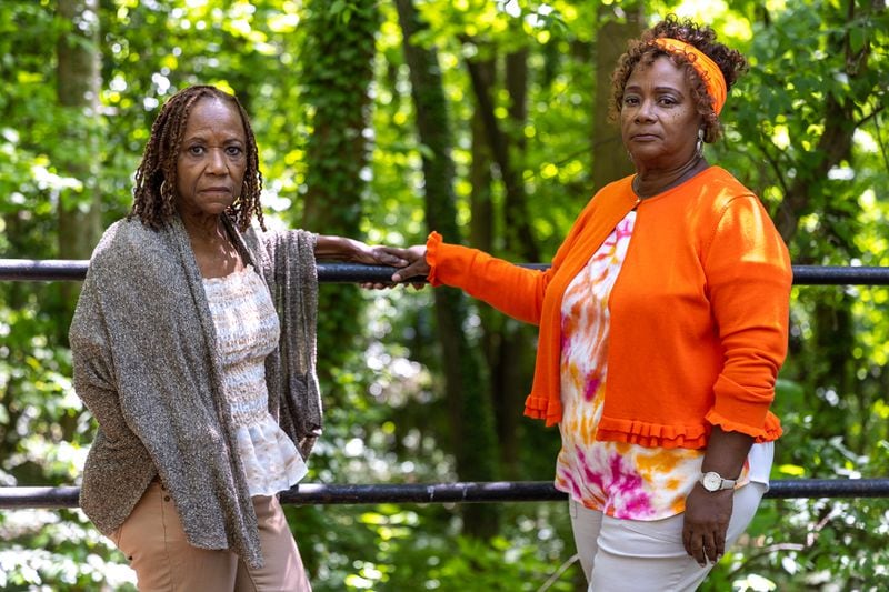 Audrey Collins and her sister Rhonda Jackson pose for a portrait near Piney Grove Cemetery in Buckhead on Wednesday, May 3, 2023. The pair are trying to restore the ancient cemetery, which is where about 30 of their family members are buried. (Arvin Temkar / arvin.temkar@ajc.com)
