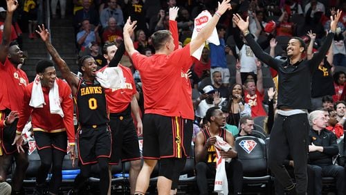 Hawks players celebrate at the end of the game in the NBA play-in tournament Wednesday at State Farm Arena. Atlanta defeated Charlotte 132-103. (Hyosub Shin / Hyosub.Shin@ajc.com)