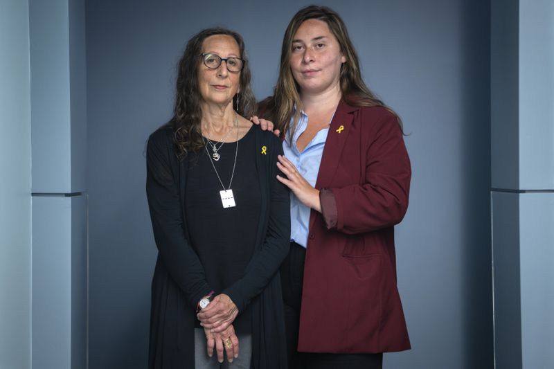 Andrea Weinstein, left, of New Haven, Conn., whose sister, Judy Weinstein, 70, and brother-in-law Gad Haggai, were killed by Hamas on Oct. 7, 2023, and their bodies taken to Gaza, poses for a portrait with her daughter Lea Silvert, of Boston, after being interviewed with fellow families of Americans being held hostage in Gaza by Hamas, Wednesday, June 5, 2024, in Washington. "We didn't even know that they'd been killed until December," says Weinstein. (AP Photo/Jacquelyn Martin)