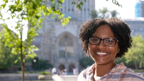 Chelesa Fearce, a Clayton County student who overcame homelessness to become her high school class valedictorian in 2013, stands in front of the Sterling Memorial Library at Yale University. She is working on her doctorate and a medical degree at the Yale School of Medicine. MICHELLE MCLOUGHLIN / FOR THE ATLANTA JOURNAL-CONSTITUTION