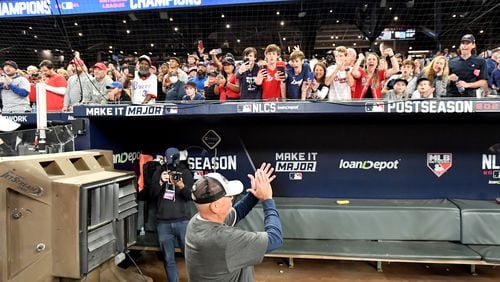 Braves manager Brian Snitker reacts to fans as they celebrate the  team's 4-2 win over the Los Angeles Dodgers in Game 6 of the National League Championship Series on Saturday at Truist Park. (Hyosub Shin / Hyosub.Shin@ajc.com)