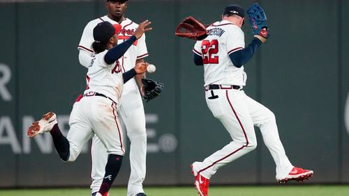 Atlanta Braves second baseman Ozzie Albies, right fielder Jorge Soler and center fielder Joc Pederson, from left, can't catch a fly ball hit hit San Francisco Giants' Brandon Crawford during the sixth inning of a baseball game Saturday, Aug. 28, 2021, in Atlanta. (AP Photo/John Bazemore)