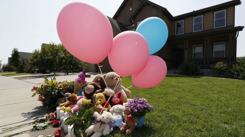 Tributes grow outside the home where a pregnant woman and her two daughters lived Thursday, Aug. 16, 2018, in Frederick, Colo. Shanann Watts' husband, Chris Watts, has been charged with murder in her death and the deaths of Bella Watts, 4, and Celeste Watts, 3, who authorities believe were killed Monday, Aug. 13, 2018, in the home. The bodies of the missing woman and children were found Thursday on the property of Chris Watts' former employer.