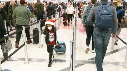 Travelers make their way to security at Hartsfield-Jackson Atlanta International Airport on Friday, which is expected to be the peak day for Christmas holiday travel  (Steve Schaefer/steve.schaefer@ajc.com)