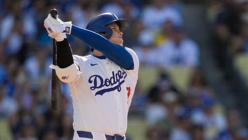 Los Angeles Dodgers designated hitter Shohei Ohtani watches his solo home run during the fifth inning of a baseball game against the Boston Red Sox, Sunday, July 21, 2024, in Los Angeles. (AP Photo/Ryan Sun)