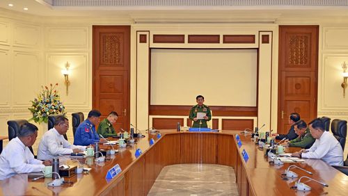 In this iamge provided by The Myanmar Military True News Information Team, Myanmar's military leader Senior Gen. Min Aung Hlaing, center, speaks during meeting with members of the National Defense and Security Council Wednesday, July 31, 2024, in Naypyitaw, Myanmar. The military regime that seized power in Myanmar 3 1/2 years ago on Wednesday extended the state of emergency in the civil war-wracked country for another six months, saying it needs time to prepare for long-promised elections. (The Myanmar Military True News Information Team via AP)