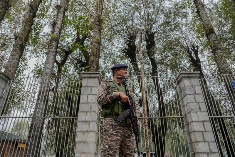 An Indian paramilitary soldier guards outside a vote counting center the recent election on the outskirts of Srinagar, Indian controlled Kashmir, Tuesday, Oct.8, 2024. (AP Photo/Mukhtar Khan)