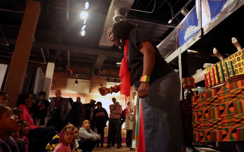 A storyteller entertains the children as a part of Kwanzaa activities at the APEX Museum. (Akili-Casundria Ramsess/Special to the AJC)