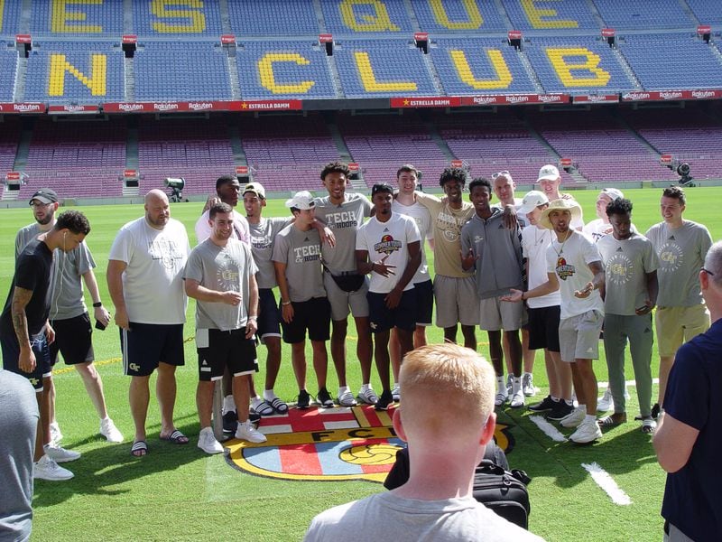 Georgia Tech players pose on the field of Camp Nou, the  home stadium of FC Barcelona, the team of the great Leo Messi. With a capacity of 99,354, it is the largest soccer stadium in Europe. (Mike Stamus/Georgia Tech Athletics)
