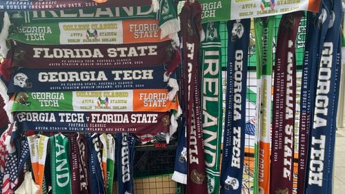 Georgia Tech and Florida State fans had many options for scarves at a kiosk in downtown Dublin prior to the Aug. 24, 2024 meeting between the two teams. (AJC photo by Ken Sugiura