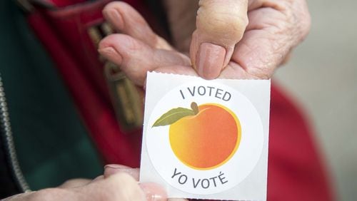 An early voter displays their “I Voted” sticker during early voting for the presidential primary at the Gwinnett Voter Registrations and Elections office building in Lawrenceville, Monday, March 2, 2020. (ALYSSA POINTER/ALYSSA.POINTER@AJC.COM)