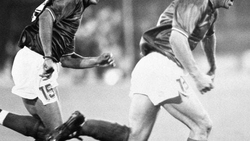 Italy's Salvatore "Totò Schillaci, right, celebrates with teammate Roberto Baggio after scoring a goal during the World Cup soccer match between Italy and Uruguay, in Rome, on June 25, 1990. (LaPresse via AP)