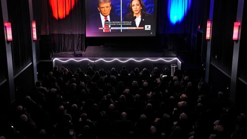 People watch the presidential debate Tuesday between the Republican nominee, former President Donald Trump, and the Democratic nominee, Vice President Kamala Harris. (AP Photo/Charlie Riedel)