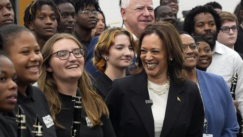 Democratic presidential nominee Vice President Kamala Harris and Democratic vice presidential candidate Minnesota Gov. Tim Walz pose for a photo with marching band members at Liberty County High School in Hinesville, Ga., Wednesday, Aug. 28, 2024. (AP Photo/Jacquelyn Martin)