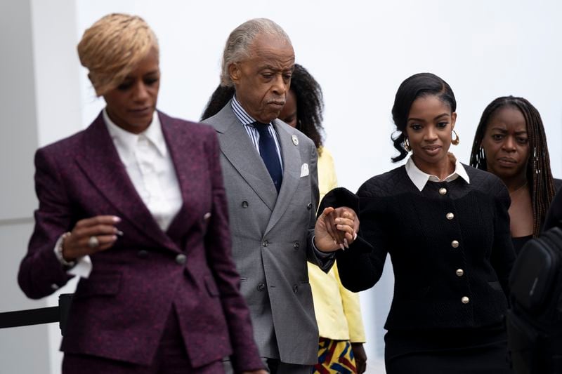 The Rev. Al Sharpton leads Fearless Fund CEO Arian Simone from the federal courthouse in Atlanta on Tues., Sept. 26, 2023. (Ben Gray / Ben@BenGray.com)