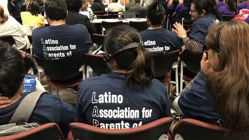 Members of the Latino Association for Parents of Public Schools use headphones to listen to an interpreter during a February meeting of the Atlanta Board of Education. VANESSA McCRAY/VANESSA.MCCRAY@AJC.COM