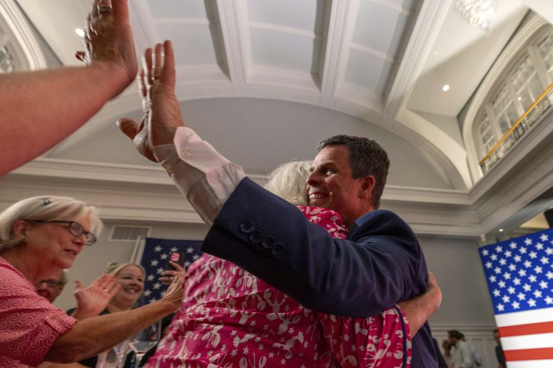 Virginia state Sen. John McGuire, a candidate in the Republican primary in the state's 5th Congressional District, joins supporters Tuesday night, June 18, 2024, in Lynchburg, Va. (AP Photo/Skip Rowland)