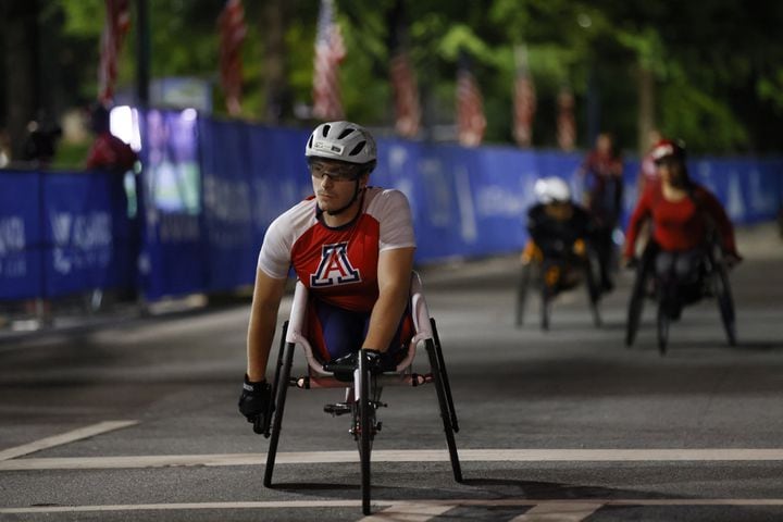Wheelchair racers arrive at the starting line of the 55th running of the Atlanta Journal-Constitution Peachtree Road Race in Atlanta on Thursday, July 4, 2024.   (Miguel Martinez / Miguel Martinez / AJC)