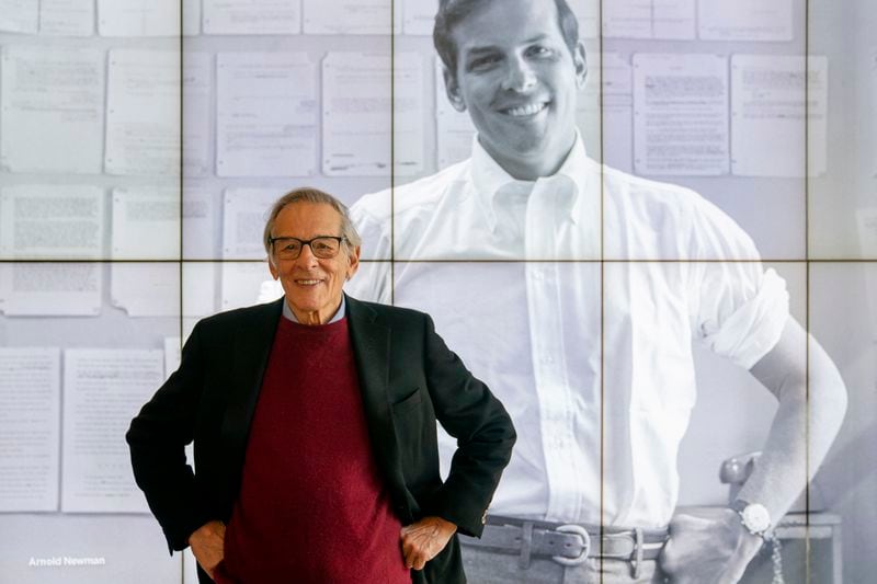 FILE - Author and biographer Robert Caro stands beside an image of his younger self after touring a permanent exhibit in his honor at the New York Historical Society Museum & Library in New York on Oct. 20, 2021. (AP Photo/John Minchillo, File)