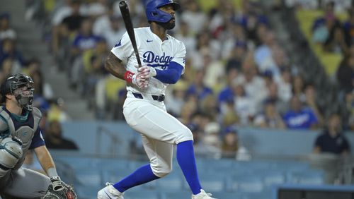 Los Angeles Dodgers Jason Heyward (23) hits a pinch hit three-run home run in the eighth inning of a baseball game against the Seattle Mariners, Tuesday, Aug. 20, 2024, in Los Angeles. (AP Photo/Jayne-Kamin-Oncea)