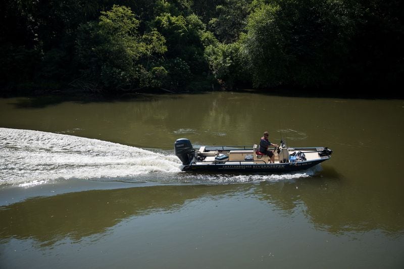 Chattahoochee Riverkeeper Executive Director Jason Ulseth scours the river for irregularities during a boat patrol ride with the organization on June 12. (Riley Bunch/The Atlanta Journal-Constitution/TNS)