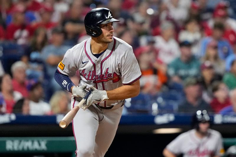 Atlanta Braves' Matt Olson follows through after hitting a run-scoring double against Philadelphia Phillies pitcher Yunior Marte during the seventh inning of a baseball game, Friday, Aug. 30, 2024, in Philadelphia. (AP Photo/Matt Slocum)