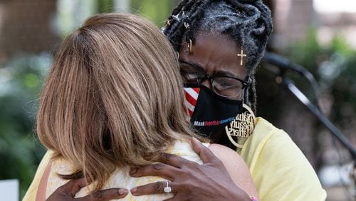 Marjorie Roberts (right), who is a COVID long-haul survivor, hugs Tanya Washington after speaking about how COVID affected her during a gathering at St. Luke’s Episcopal Church in Atlanta on Saturday morning, August 7, 2021, as part of National COVID Awareness Day. (Photo: Ben Gray for The Atlanta Journal-Constitution)