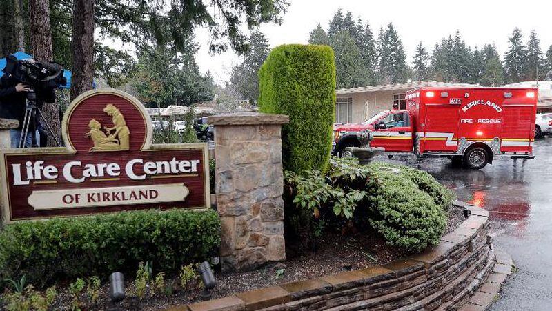 An ambulance backs into a parking lot at the Life Care Center. This ambulance left the facility after a short time and did not transport a patient. 