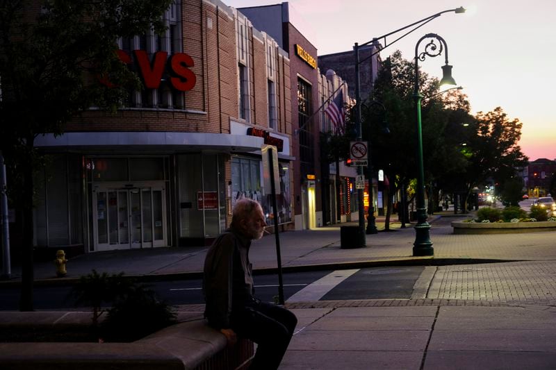 A man smokes a cigarette in front of the "Latino Americans for Trump" office in Reading, Pa., on Sunday, June 16. (AP Photo/Luis Andres Henao)