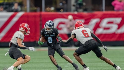 Cedar Grove’s Boden Walker (0) avoids tacklers during the Class 3A GHSA State Championship game at Mercedes-Benz Stadium, on Wednesday, Dec. 13, 2023, in Atlanta. (Jason Allen for the Atlanta Journal Constitution)